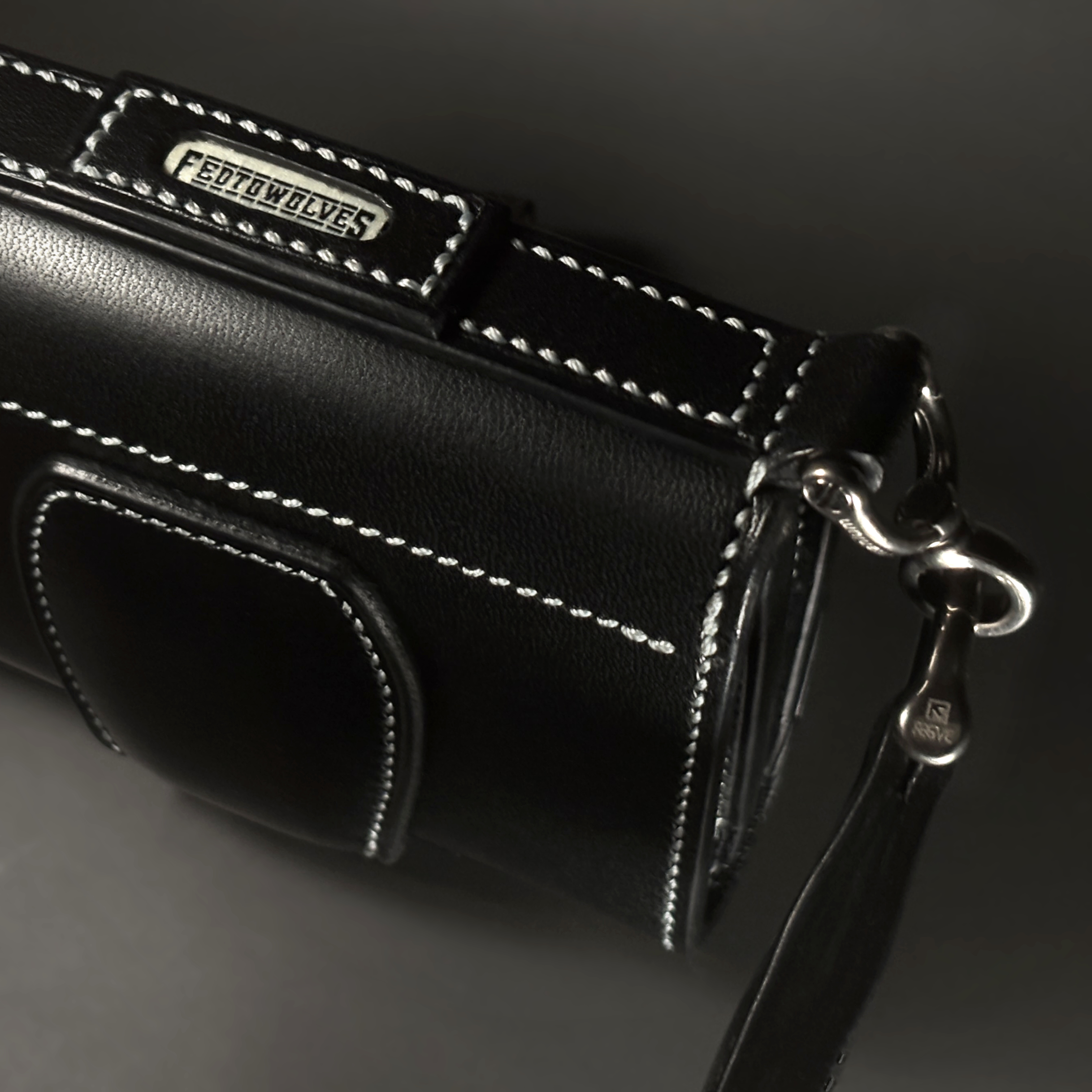 Unique handstitched black tuck closure wristlet strap purselette top titanium hardware view