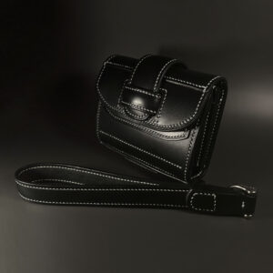 Unique handstitched black tuck closure wristlet strap purselette exterior shell front view
