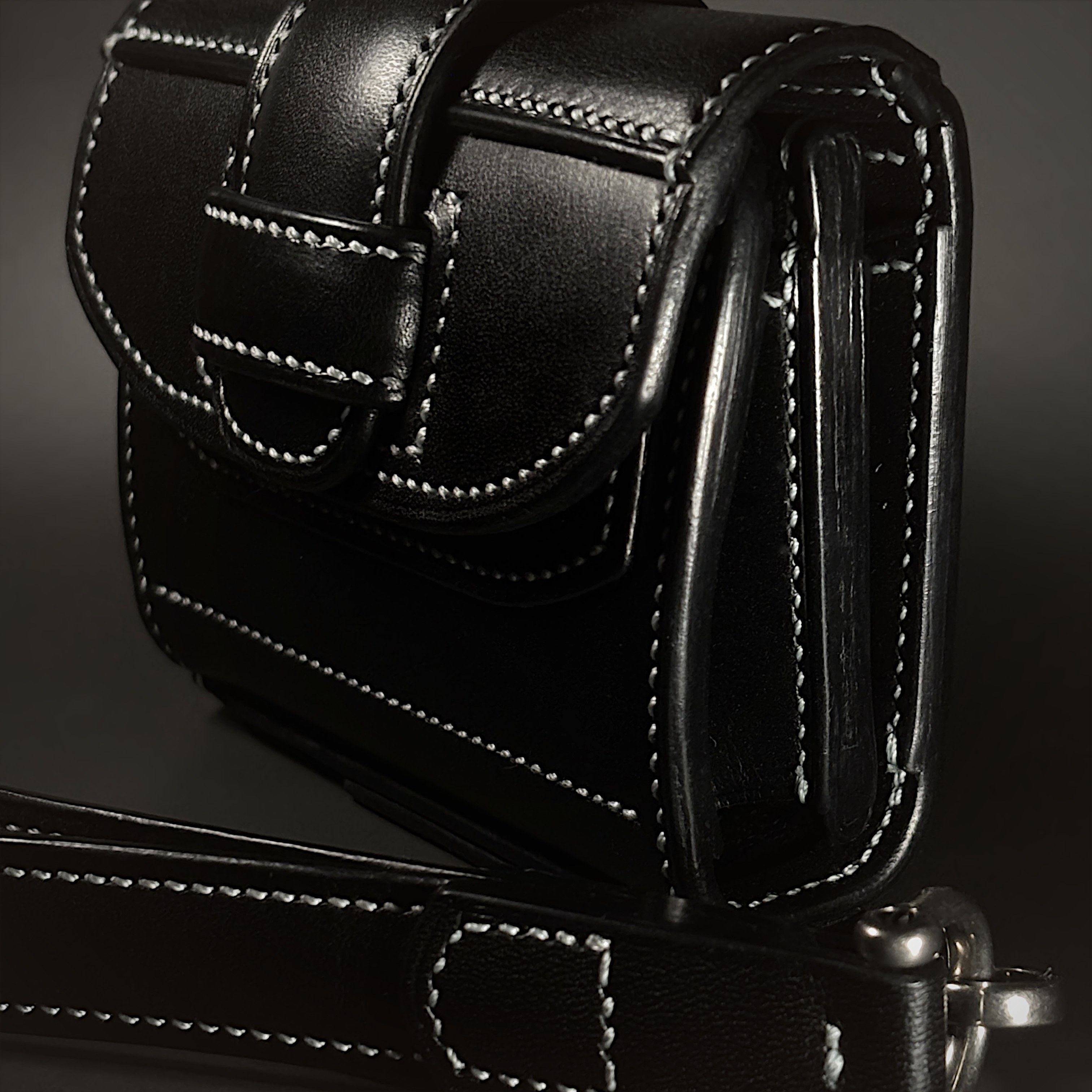 Unique handstitched black tuck closure wristlet strap purselette detail side view